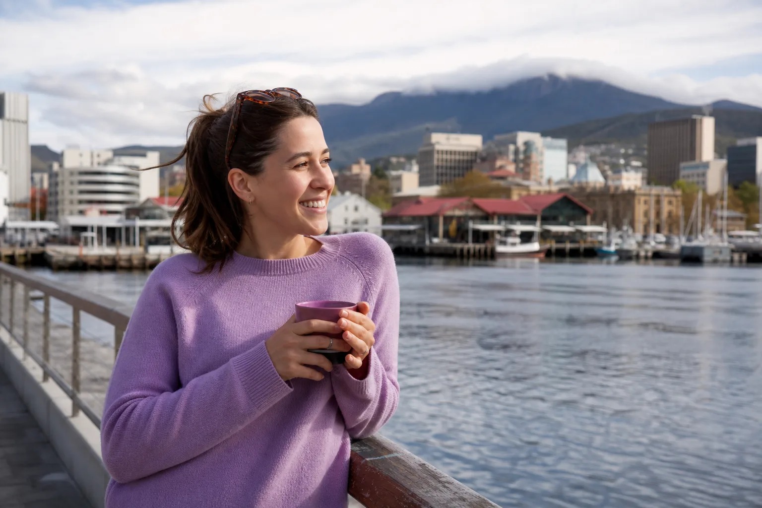 Person updating their dating profile on a phone beside Hobart's waterfront